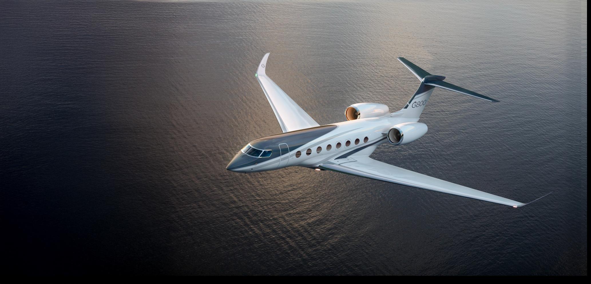 A long-range private jet banking over open ocean on a global charter