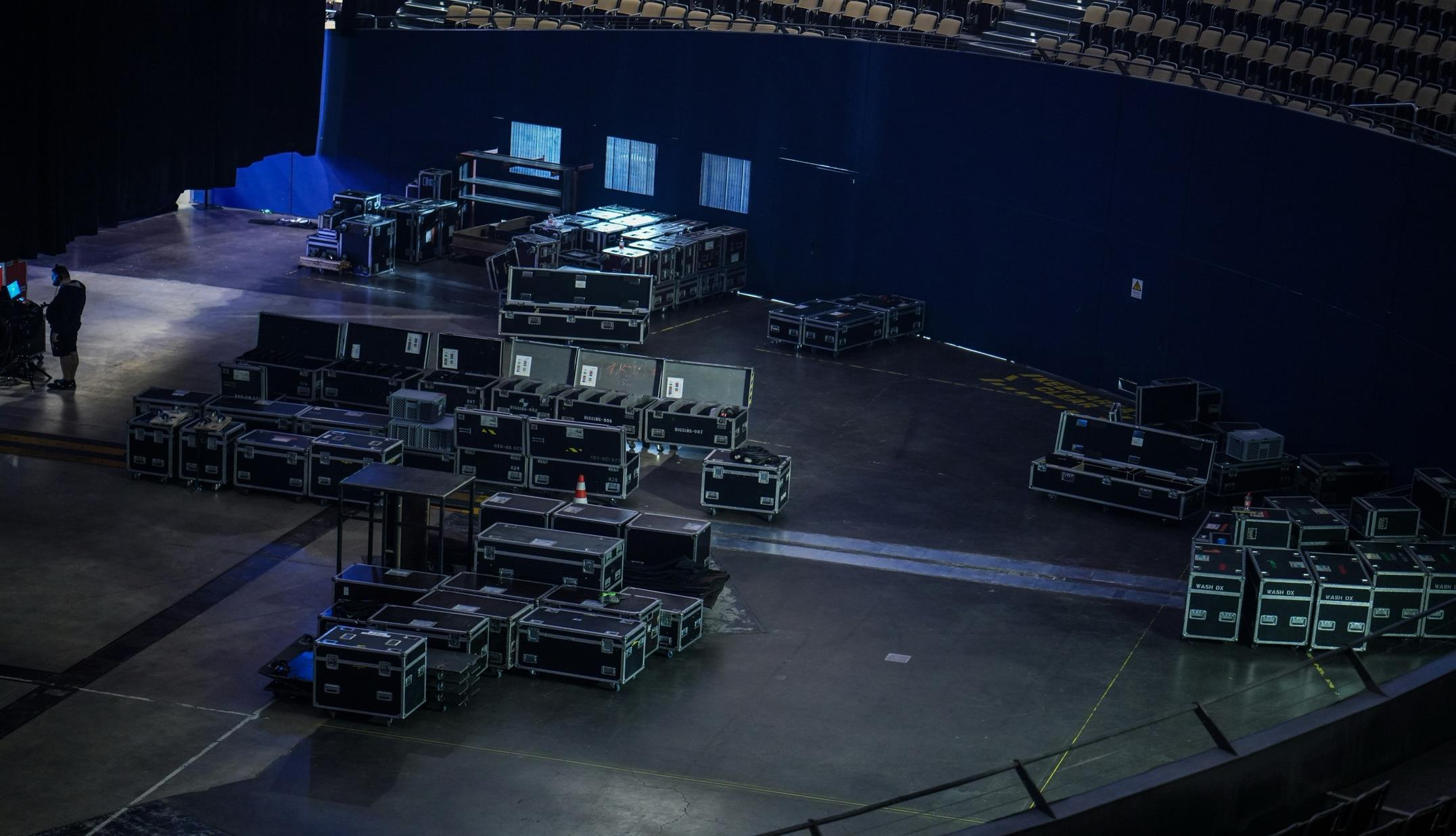 Touring production road cases staged for load-in at an arena